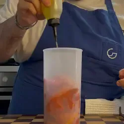 Mixer a immersione che frulla i peperoni per ottenere una crema di peperoni liscia.