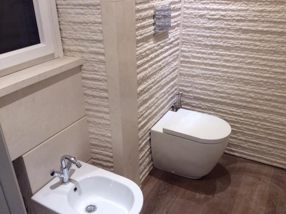 bathroom with cream stone wall tiles