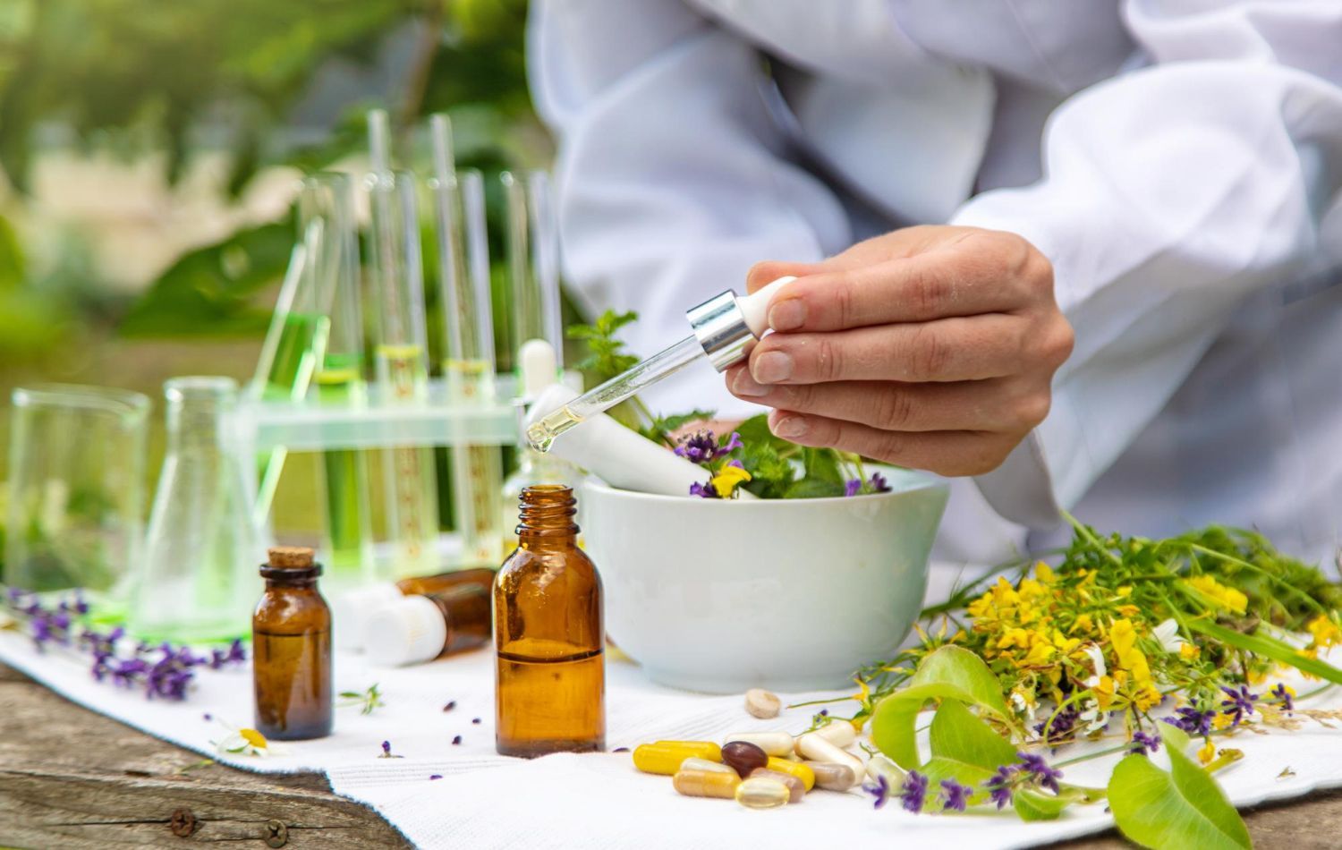 A scientist is mixing herbs in a mortar and pestle.