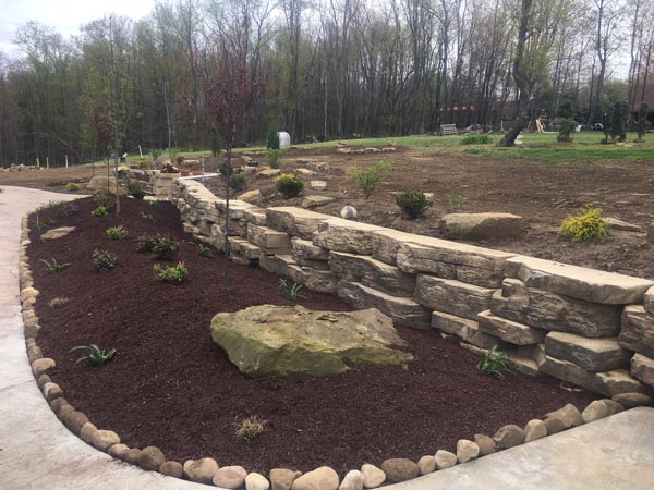 Retaining Wall Stone Patio And Shrubs — Beaver County, PA — McCreary's Lawn Care