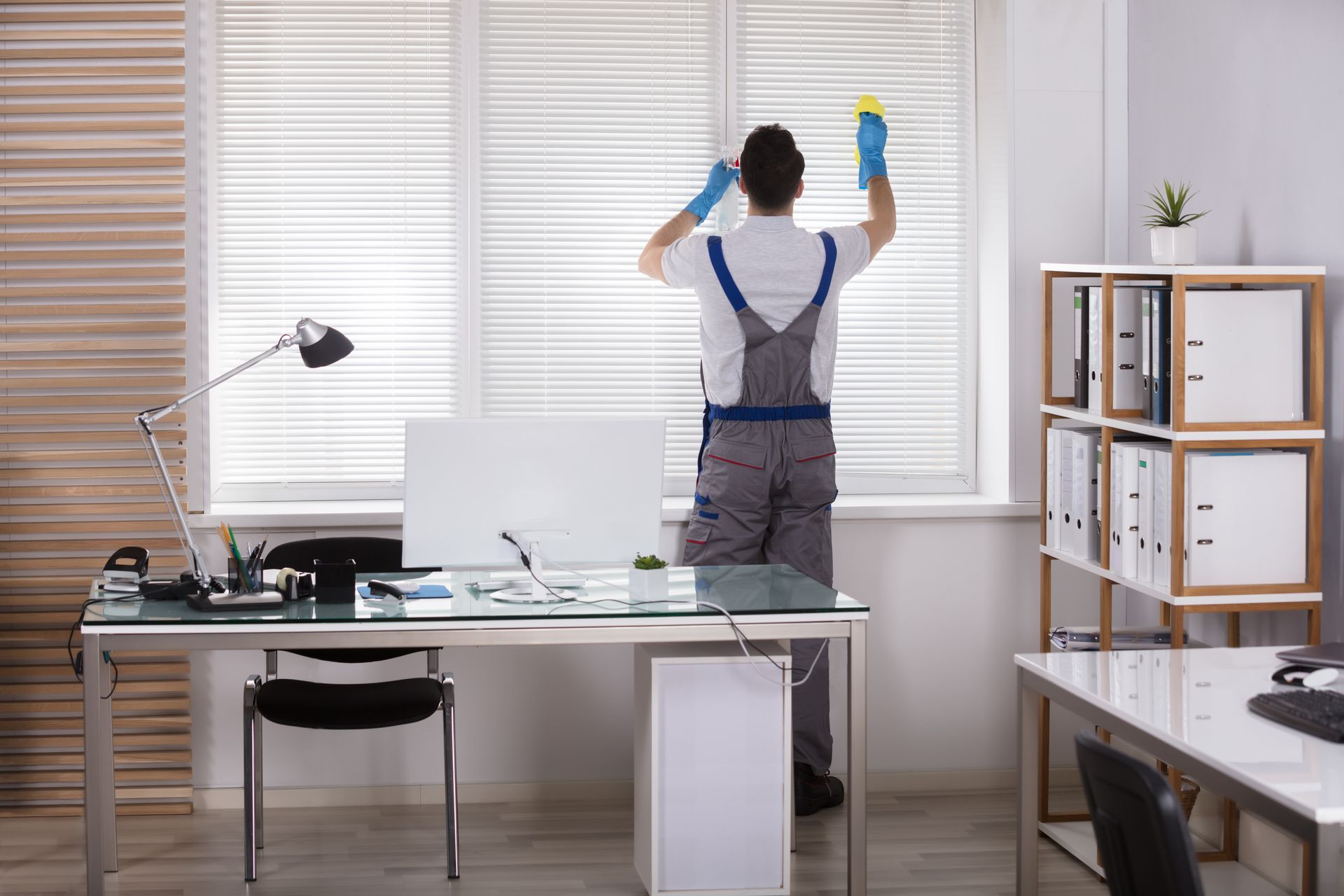 Cleaning a window in an office.