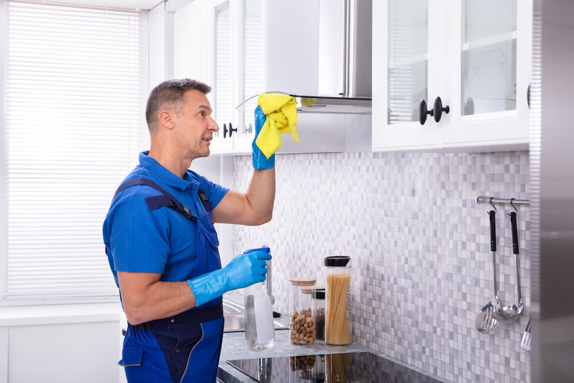 Cleaning a kitchen hood.