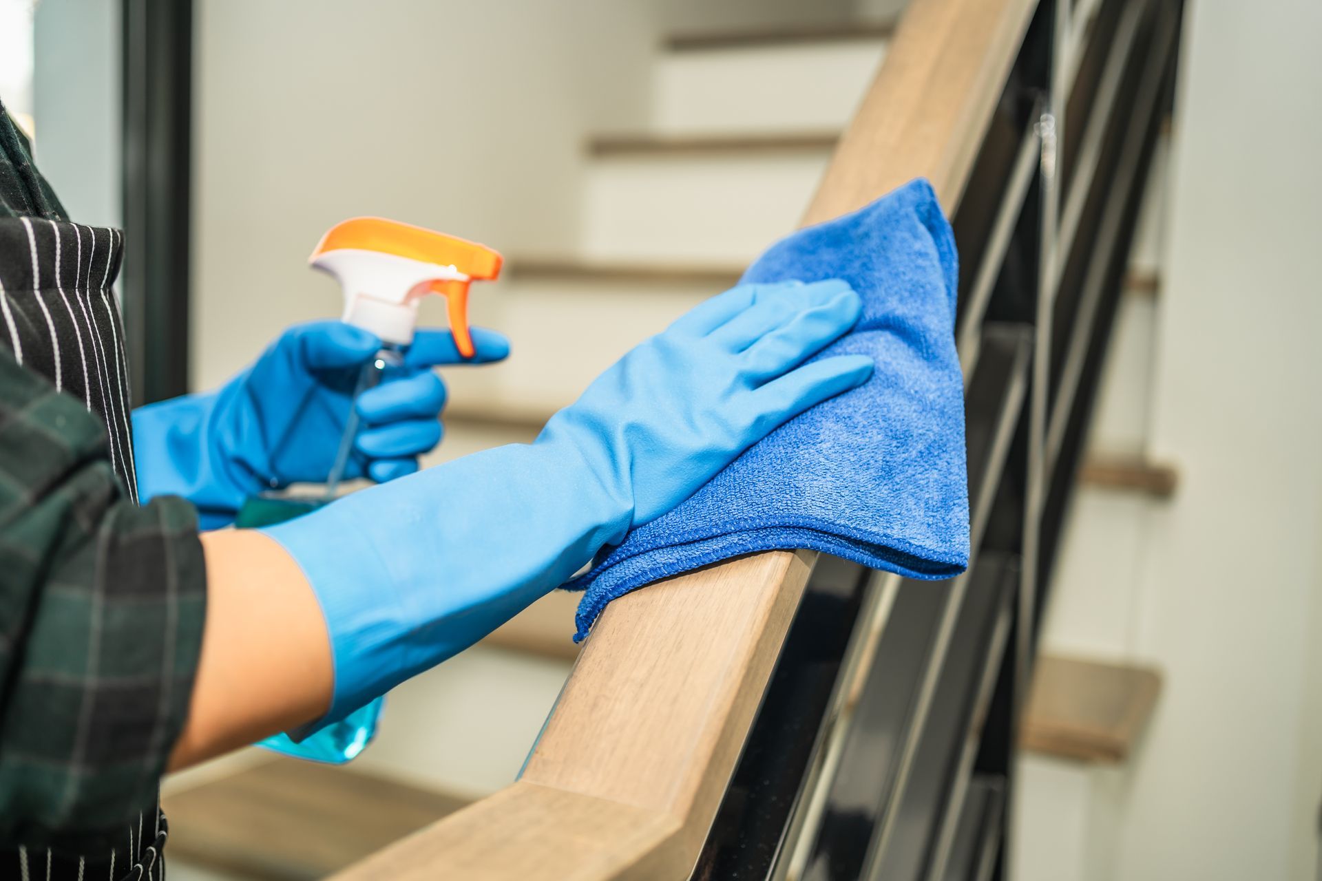 Cleaning a stair railing.