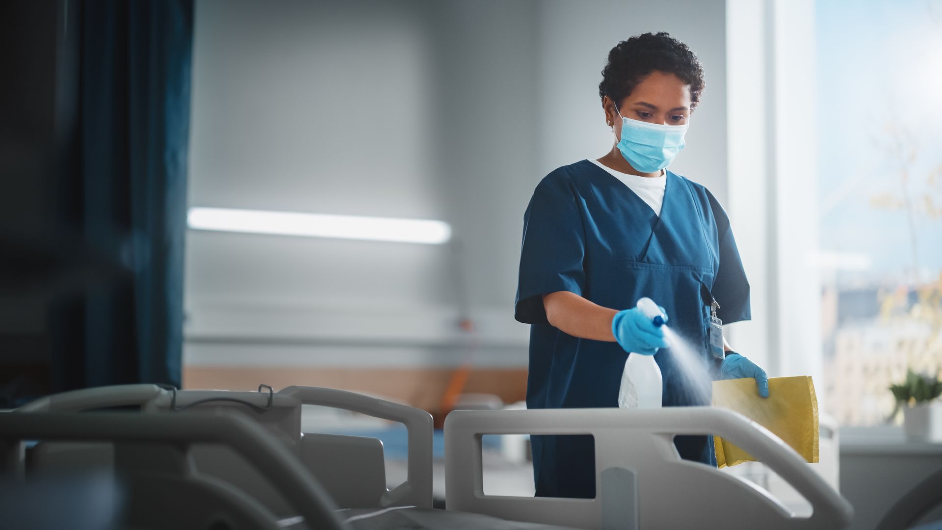 Cleaning a hospital bed.