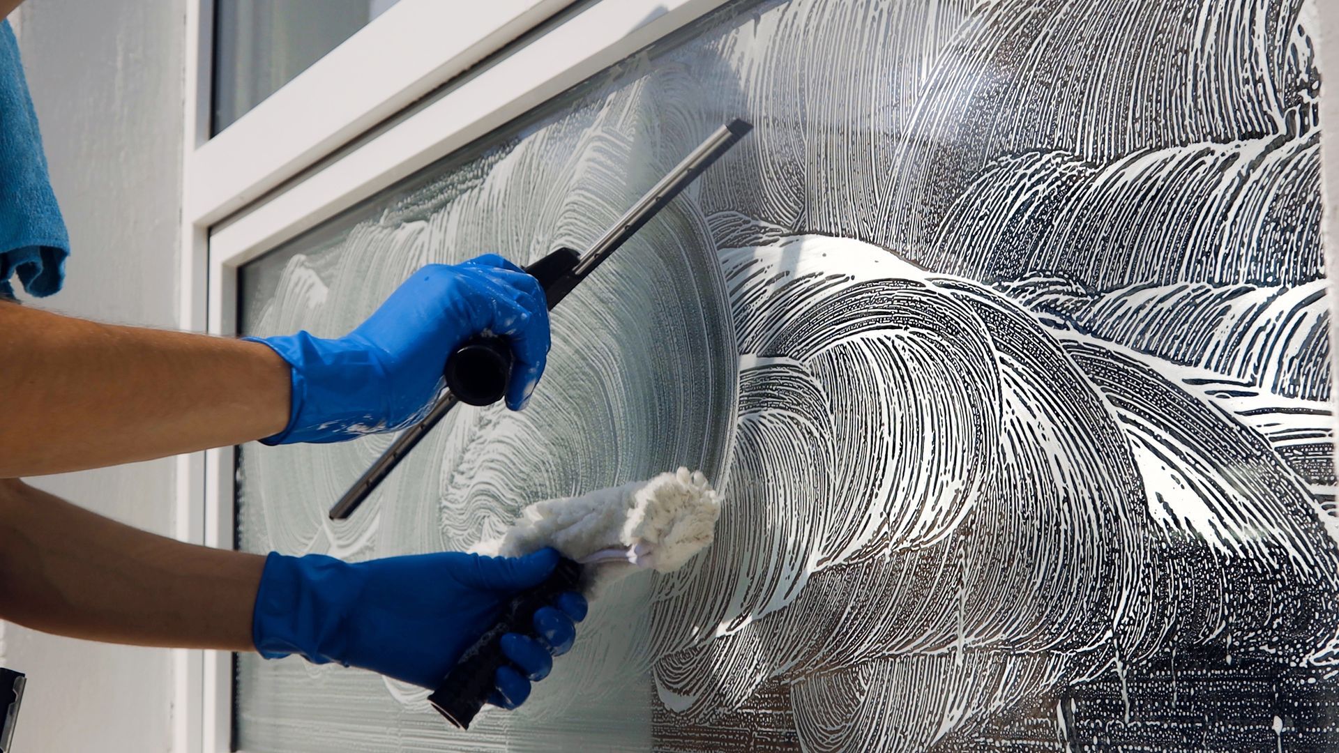 Cleaning a window with a brush.