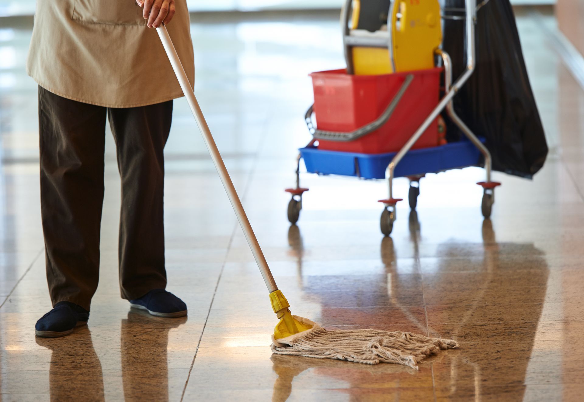 A man is mopping the floor.
