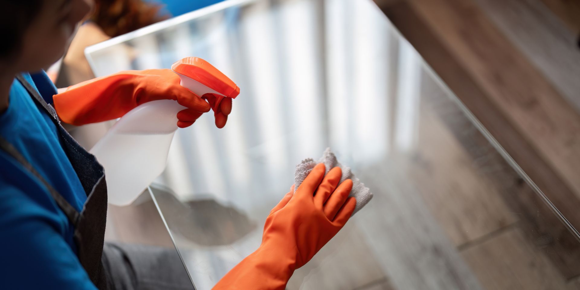 Cleaning a window with a spray bottle.