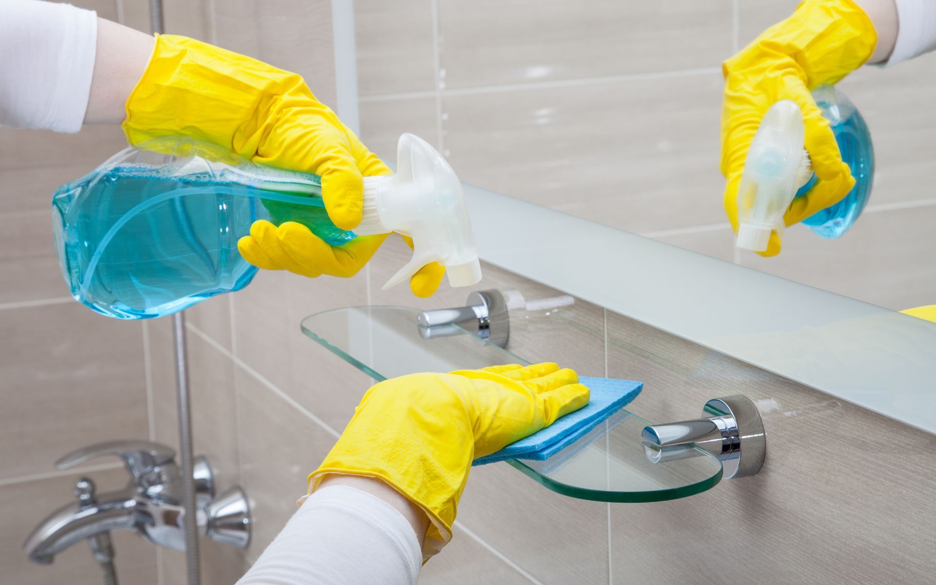 Cleaning a bathroom mirror.