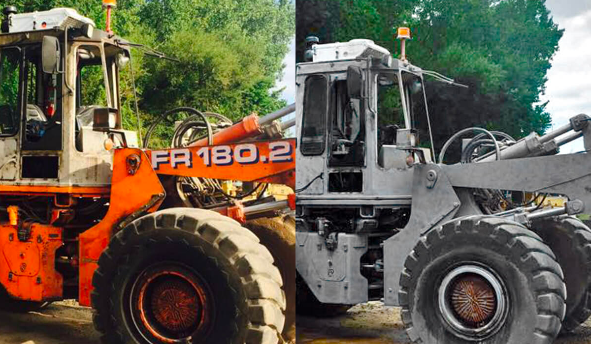 Two tractors are parked next to each other on a dirt road.