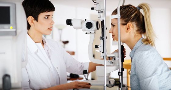 eye doctor and patient during eye exam