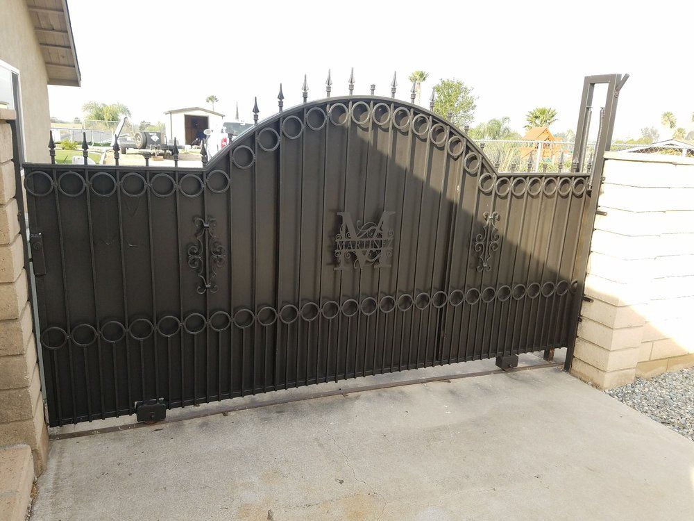 A black wrought iron gate with a castle design on it