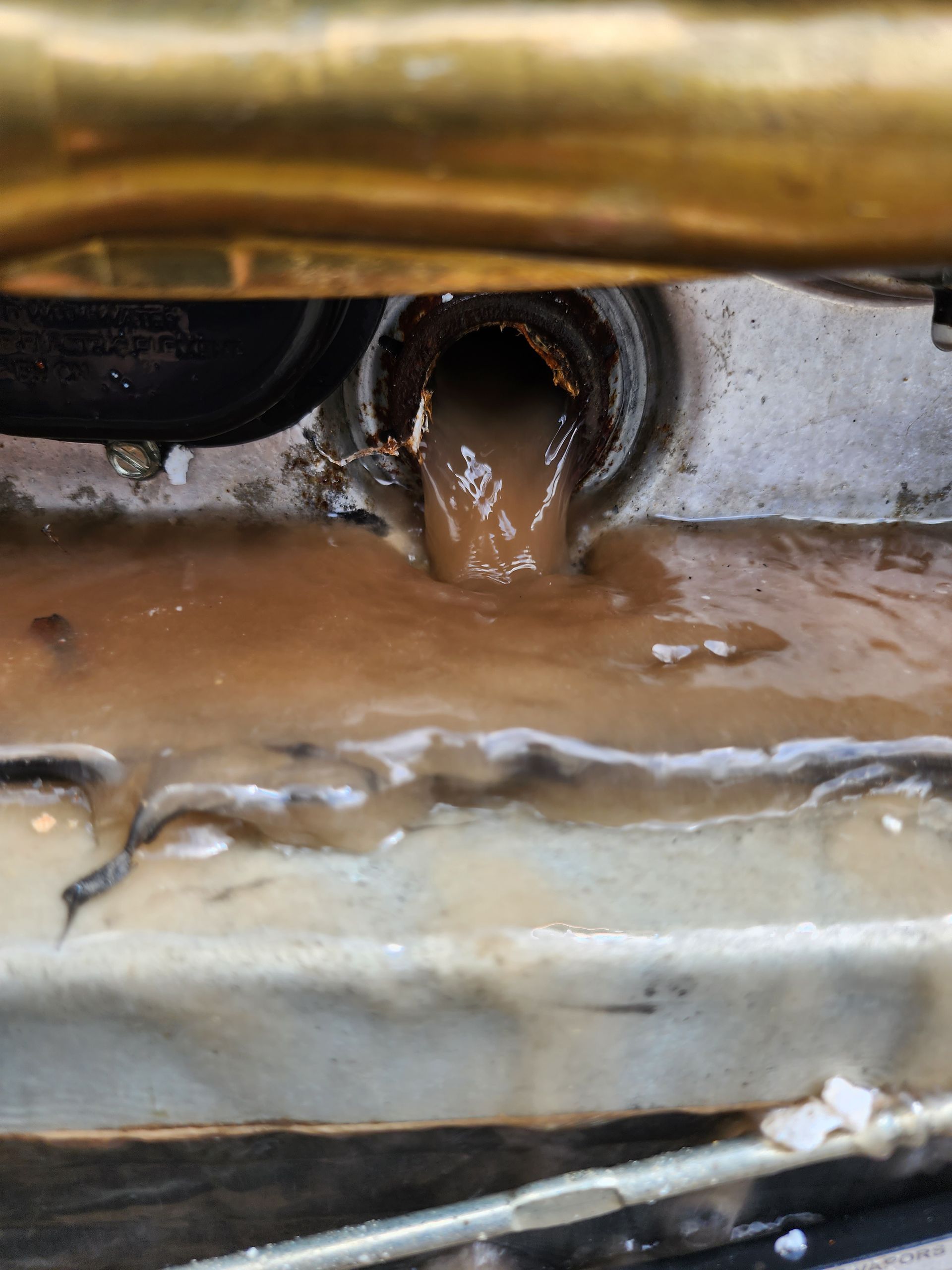 A close up of a pipe with water coming out of it.