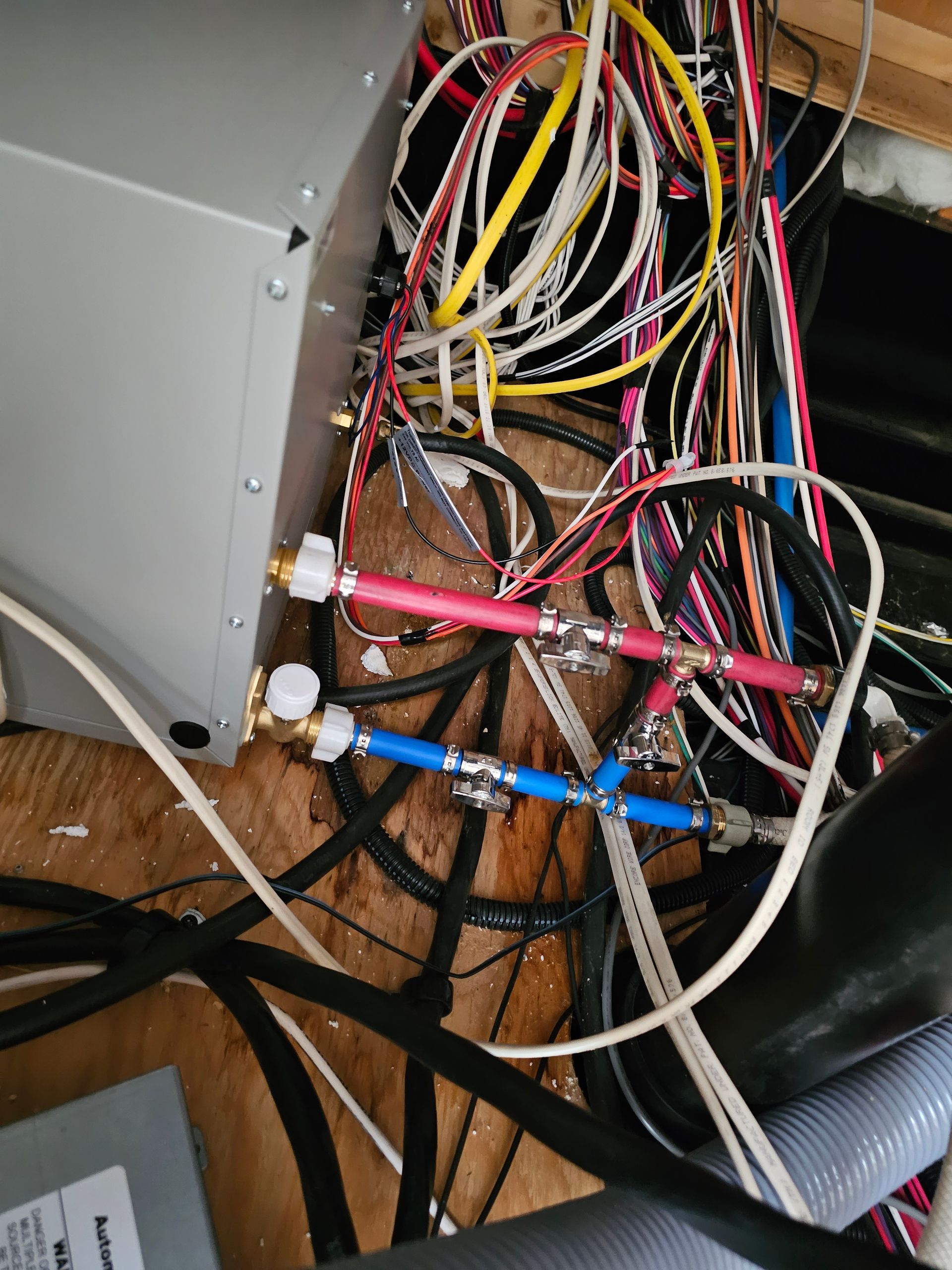 A bunch of wires and cables are connected to a box