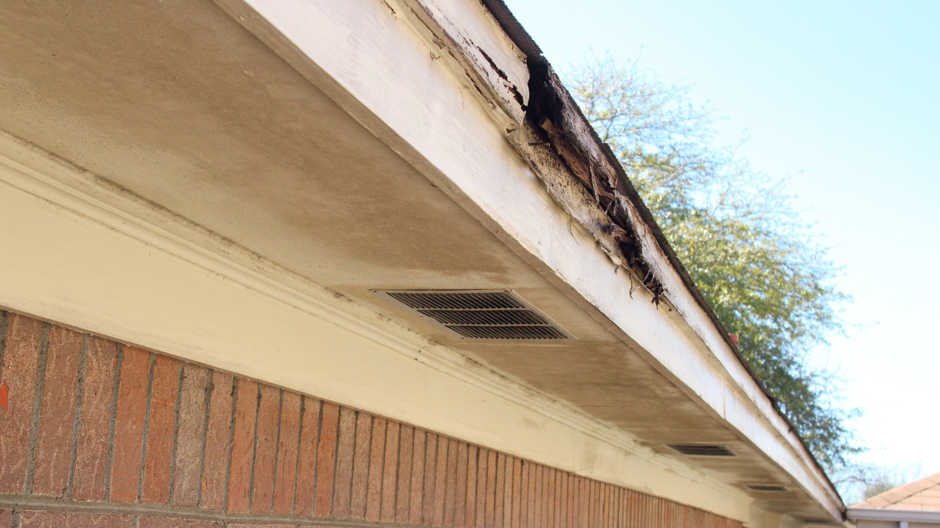 A brick building with a roof that is missing a gutter.