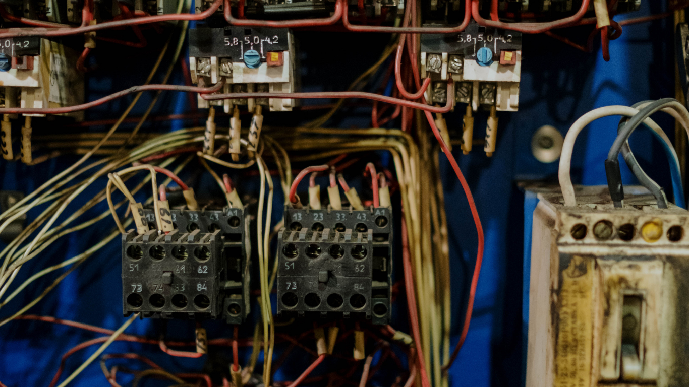 A close up of a electrical panel with a lot of wires.