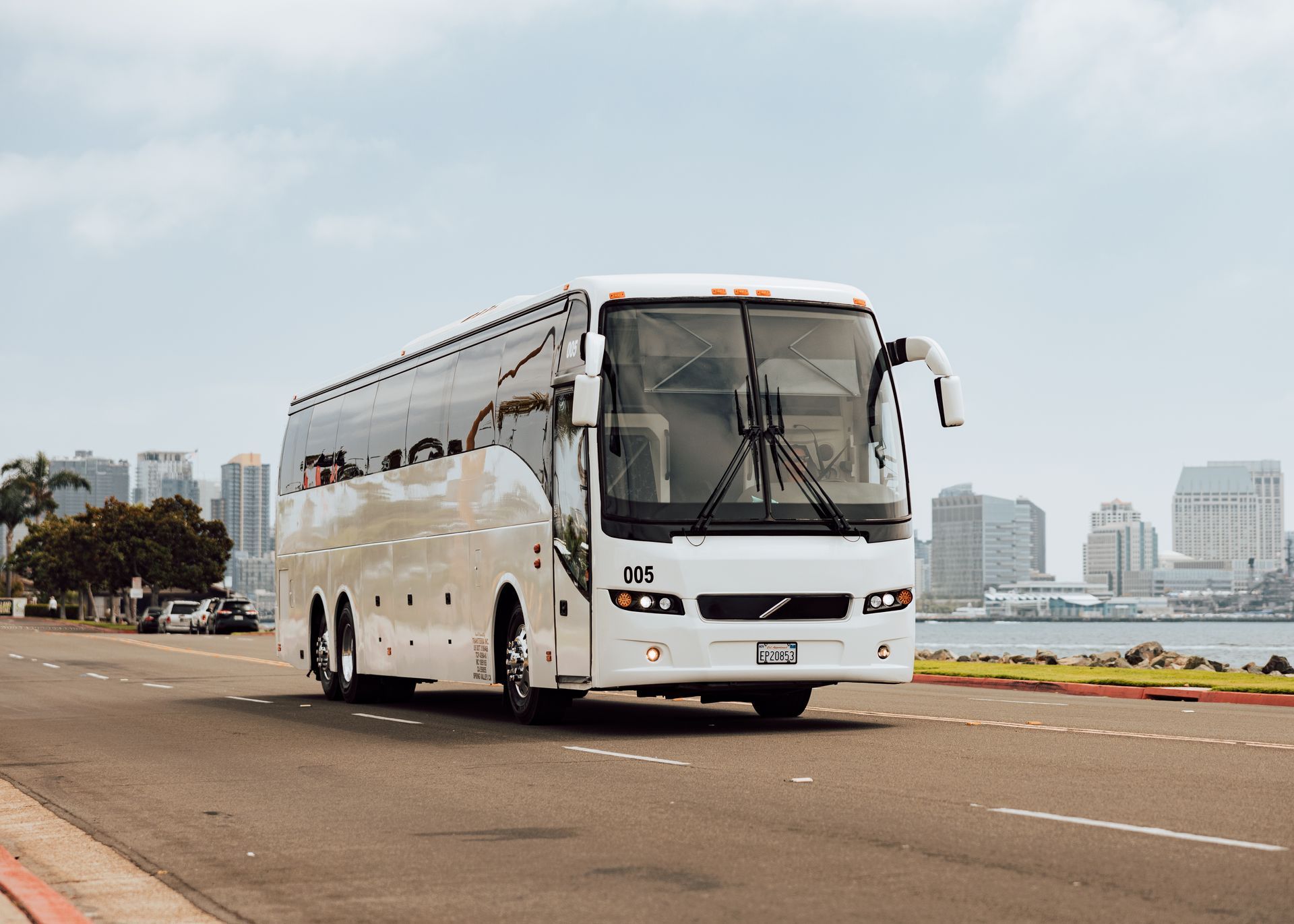 Charter bus driver in San Diego transporting a group safely in a modern bus rental from TransTerra.