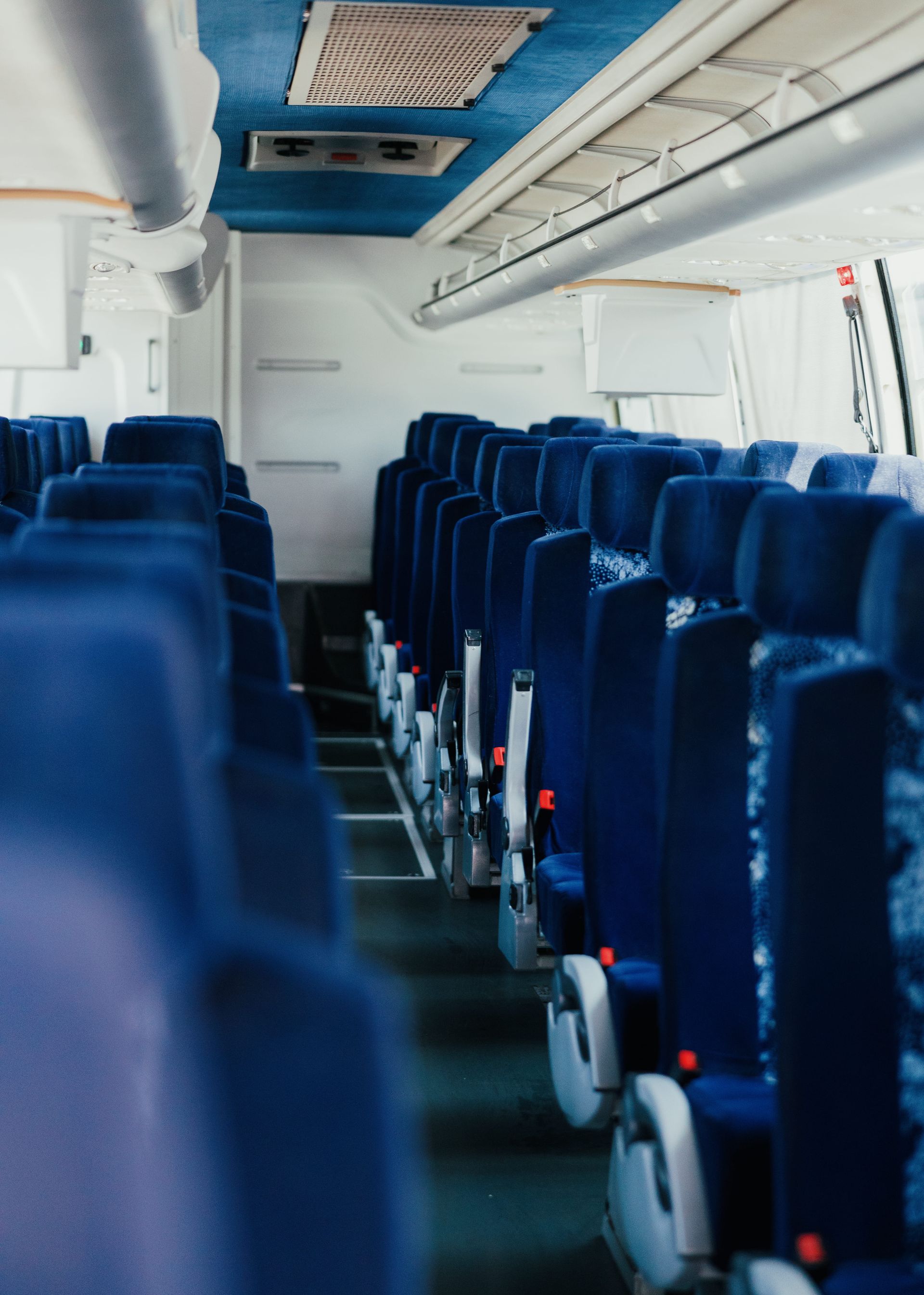 Rows of seats inside a charter bus ready for a group outing in San Diego.