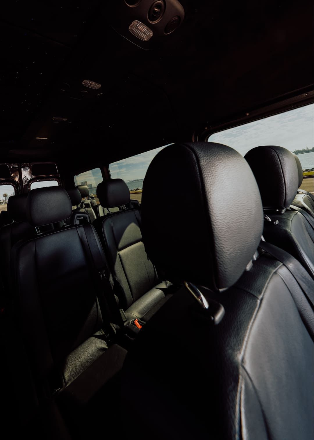 Interior close-up of cushioned seats inside a Sprinter van used for San Diego corporate event