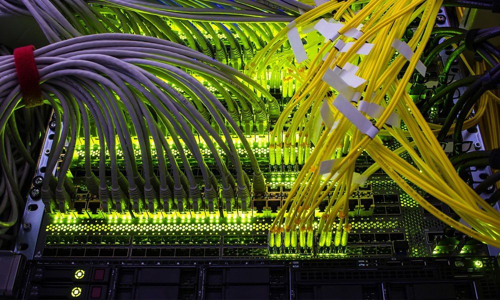 cables connected to an optic ports and UTP Network cables connected to ethernet ports.