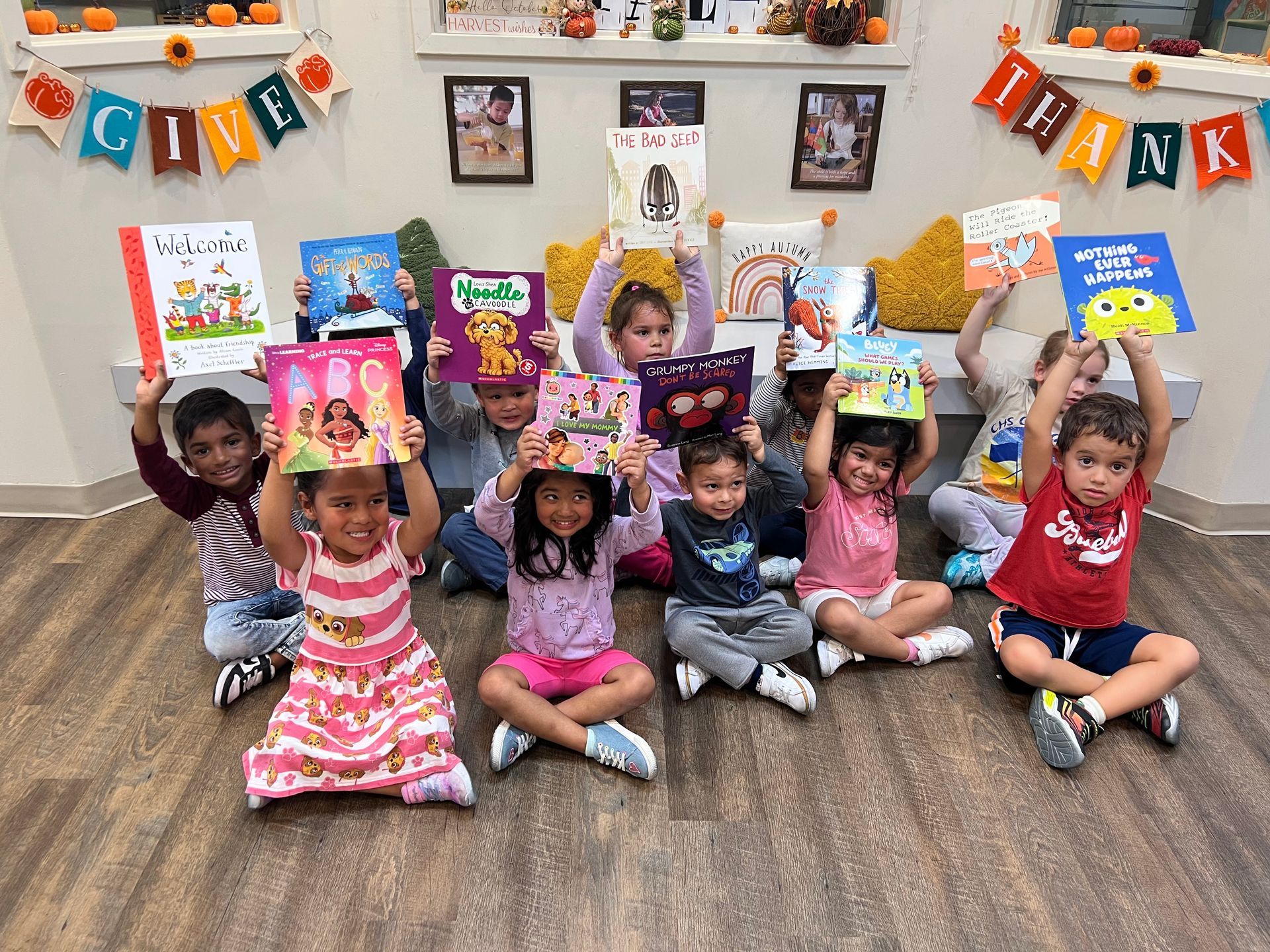 Montessori child holding books in the classroom