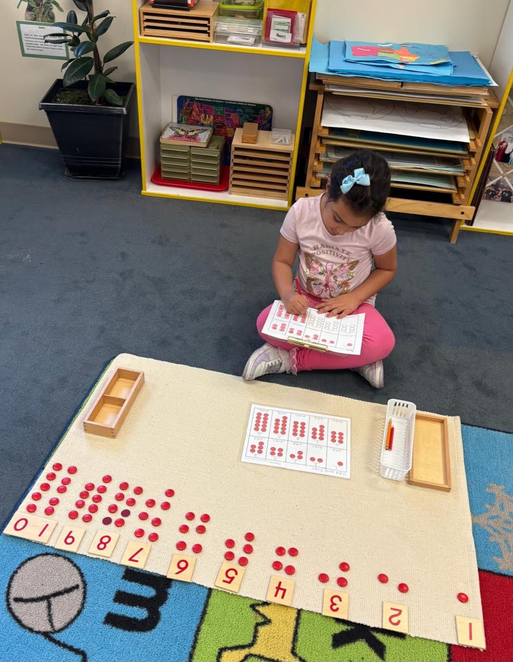 Montessori child working with math materials