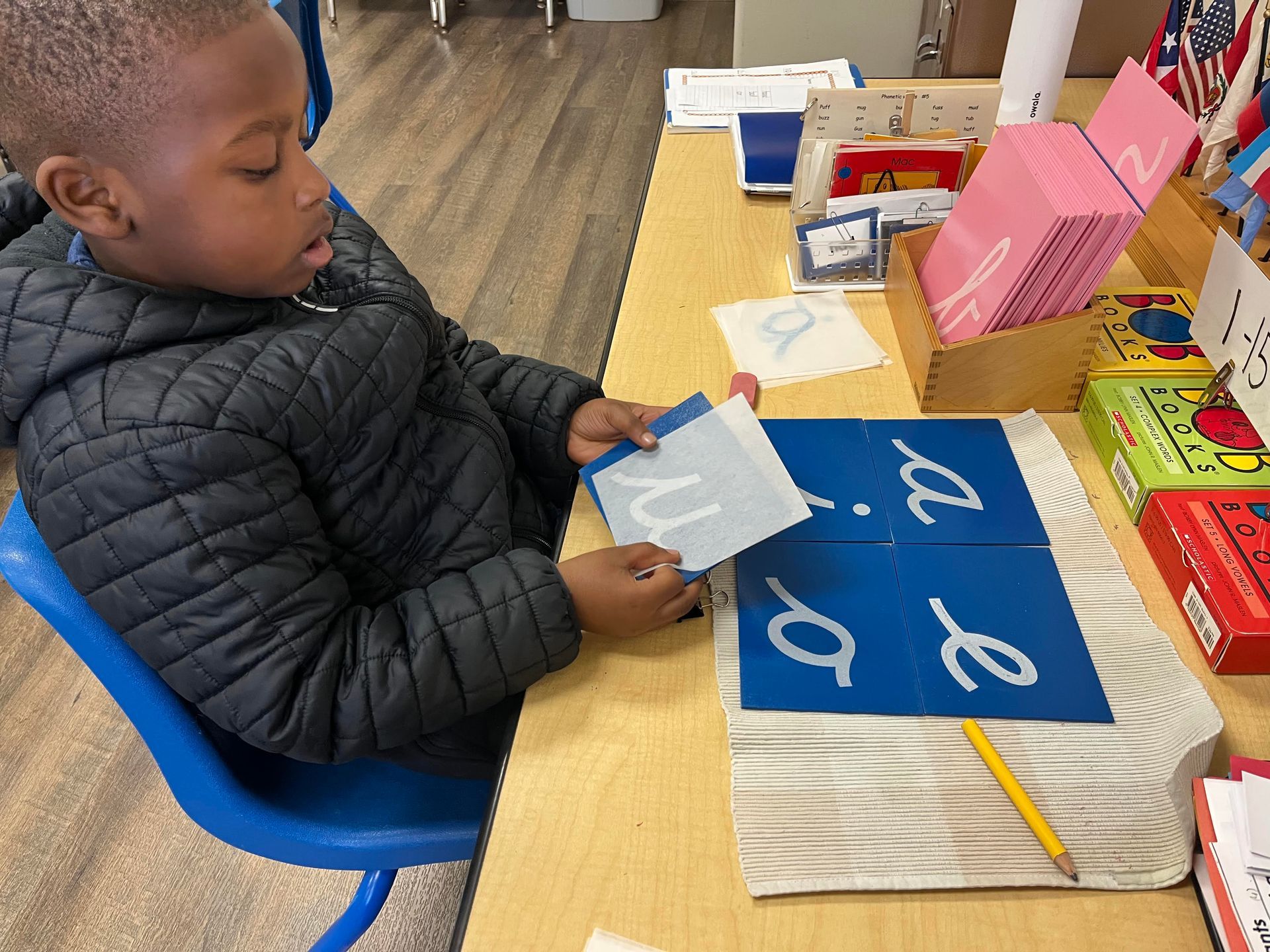 Montessori child working with language materials