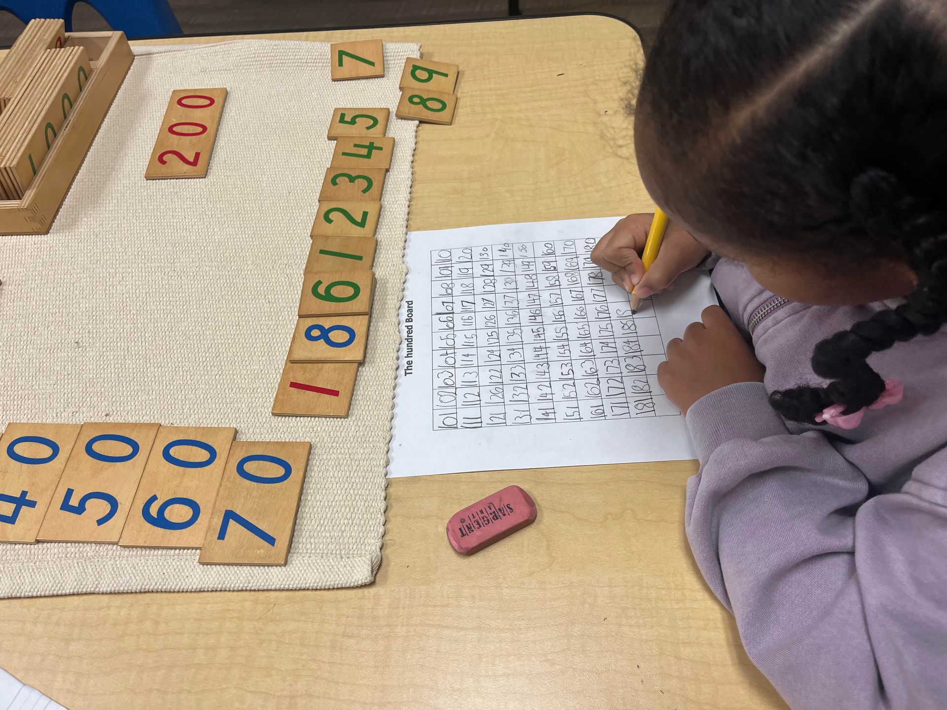 Montessori child working with math materials