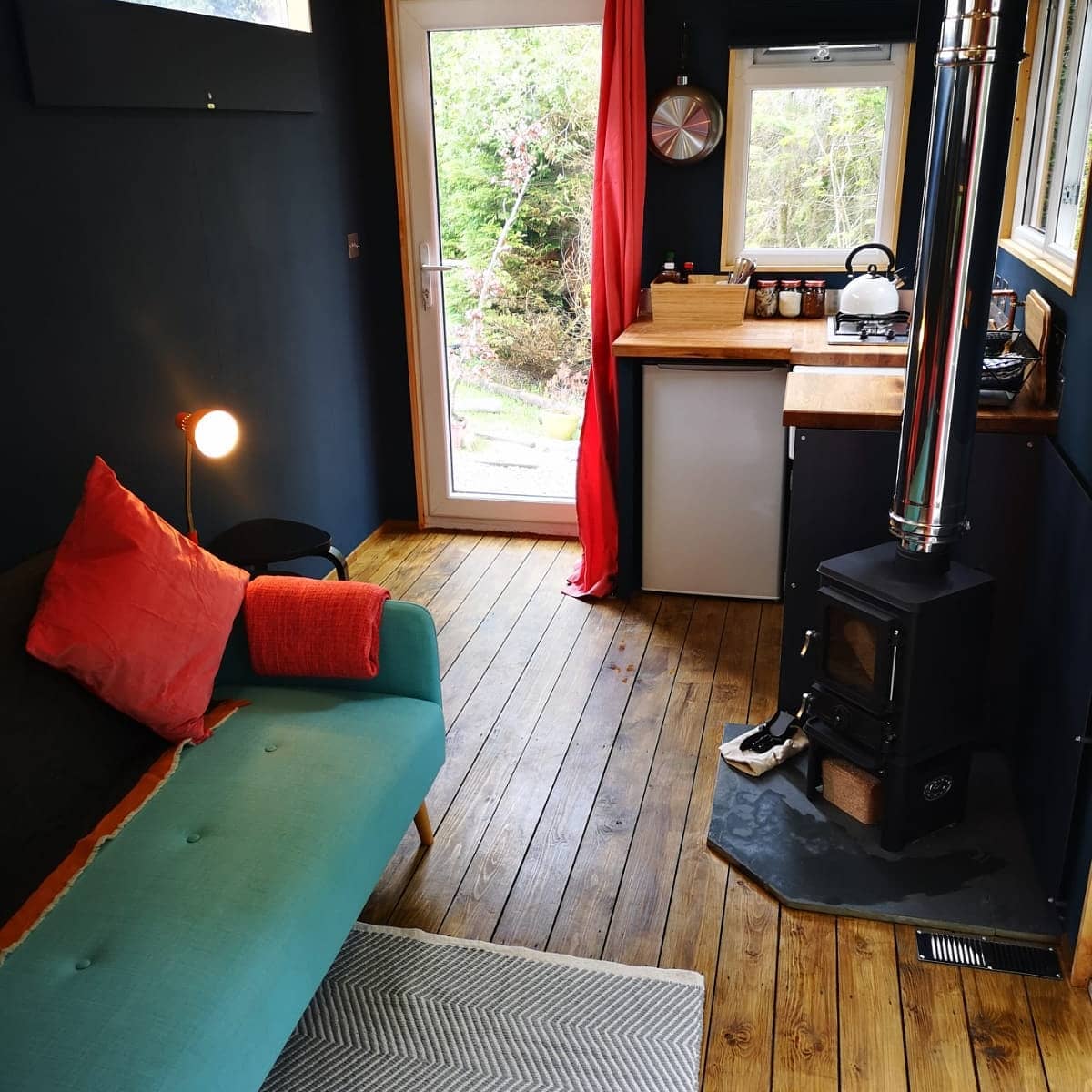 A living room with a couch and a wood stove