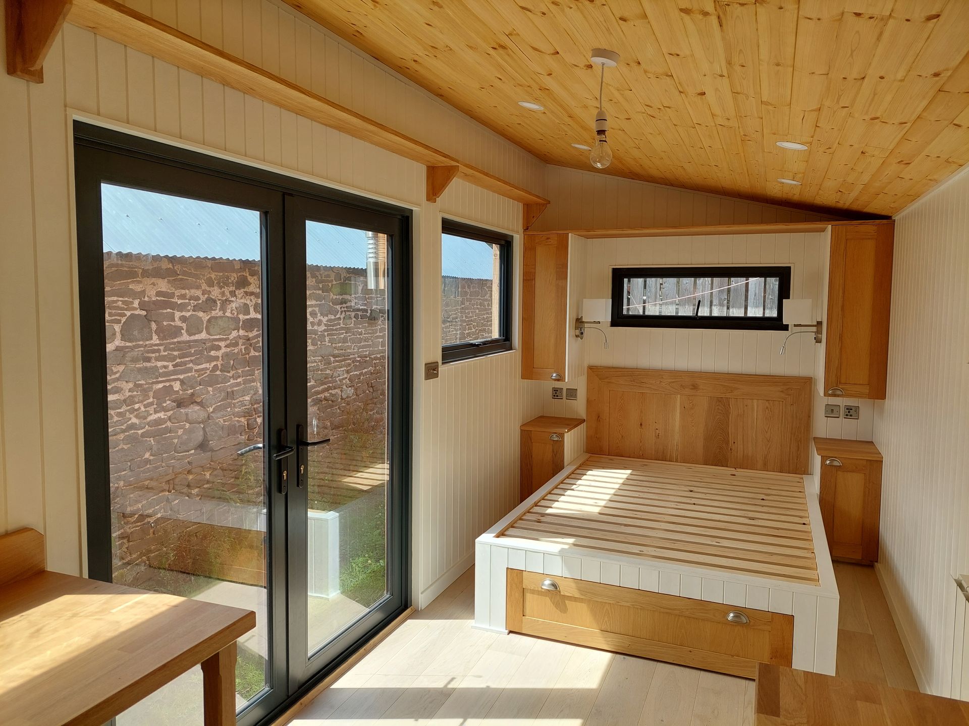A bedroom with a bed and sliding glass doors