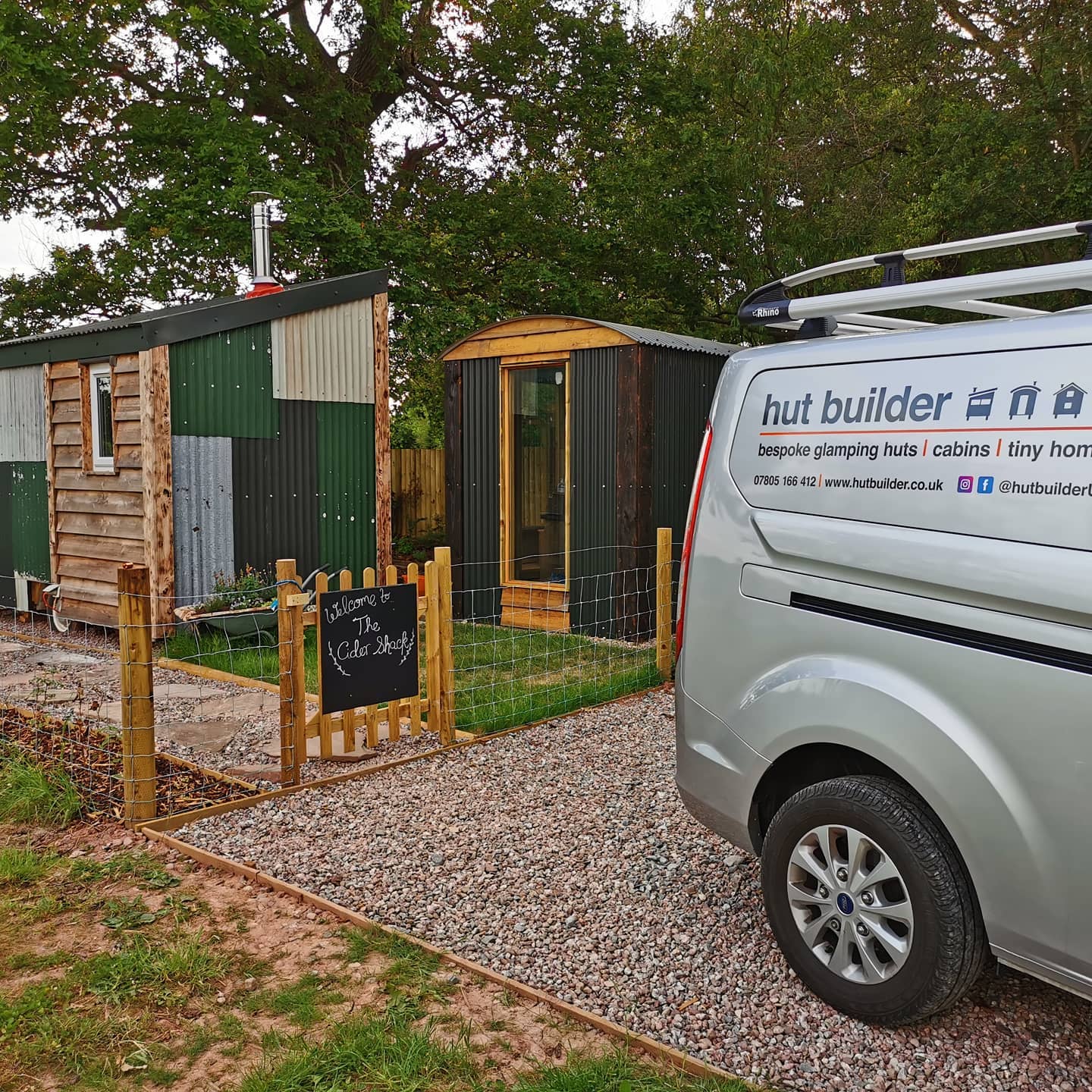 A van that says but builder is parked in front of a building