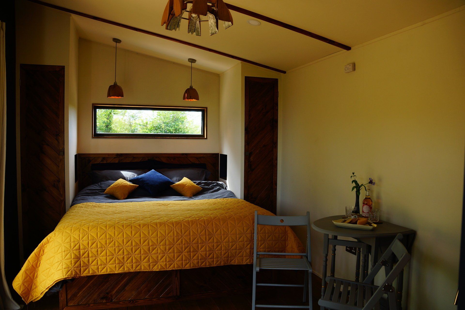 A bedroom with a large bed and a small table