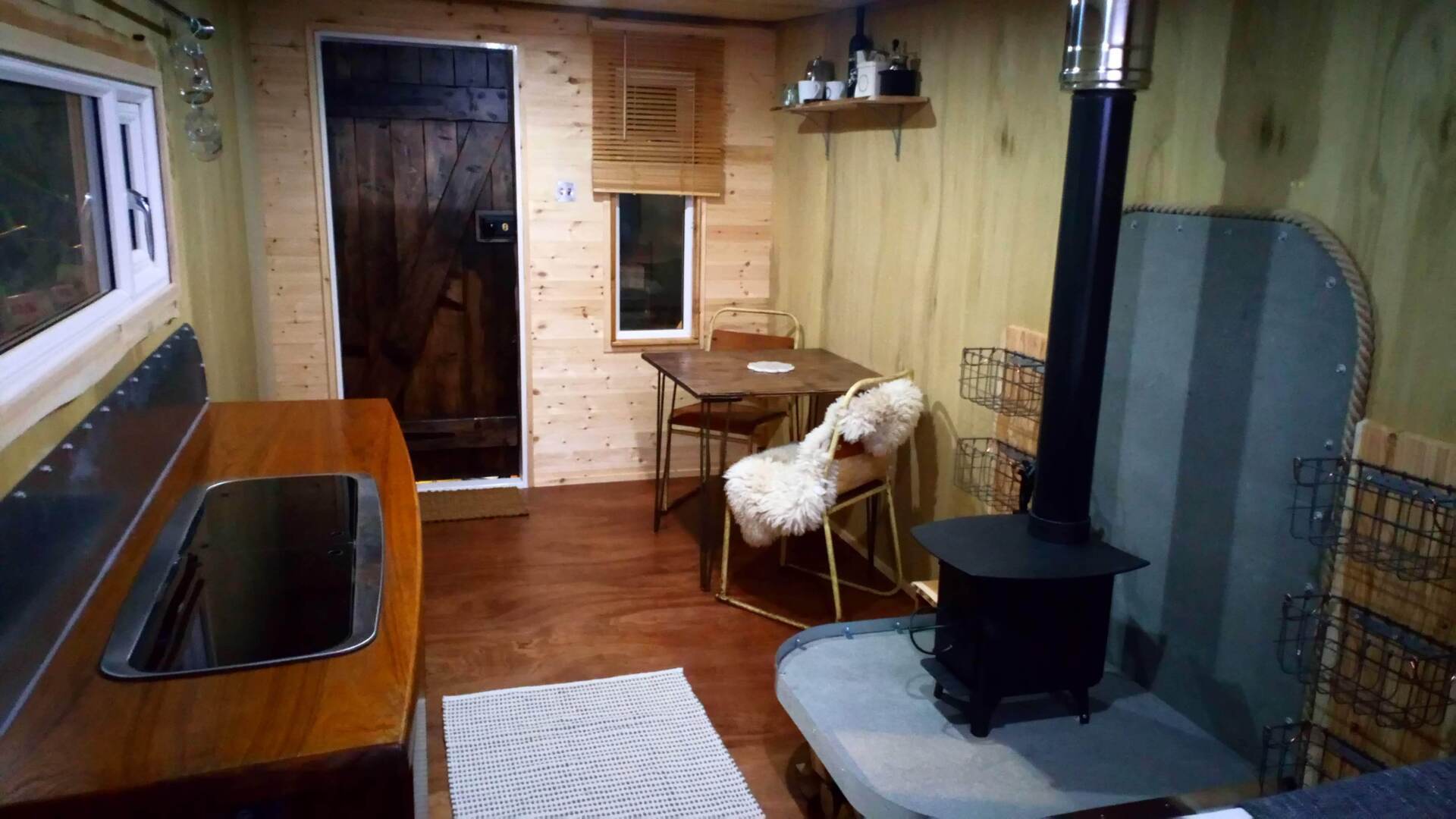 There is a wood stove in the middle of the room.