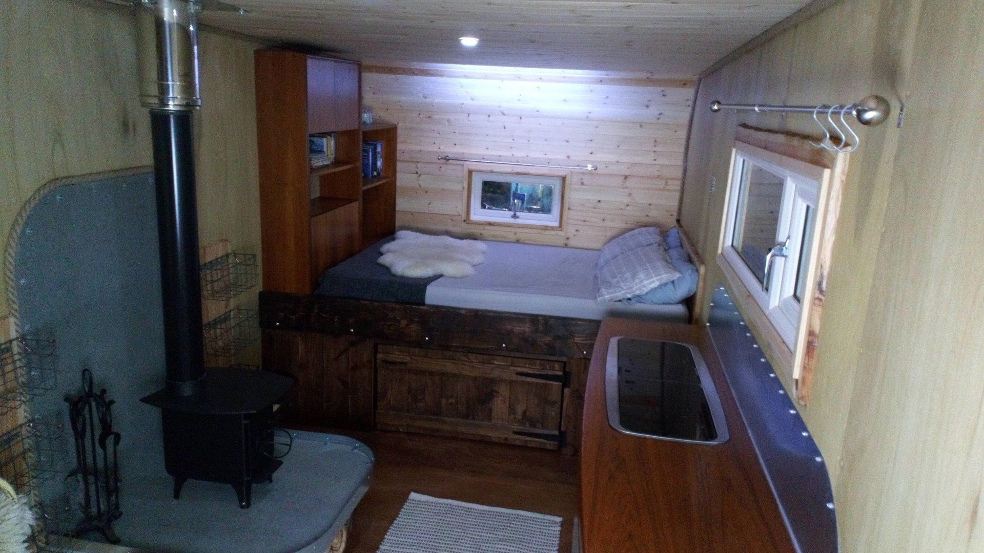A bedroom with a bed and a stove in it