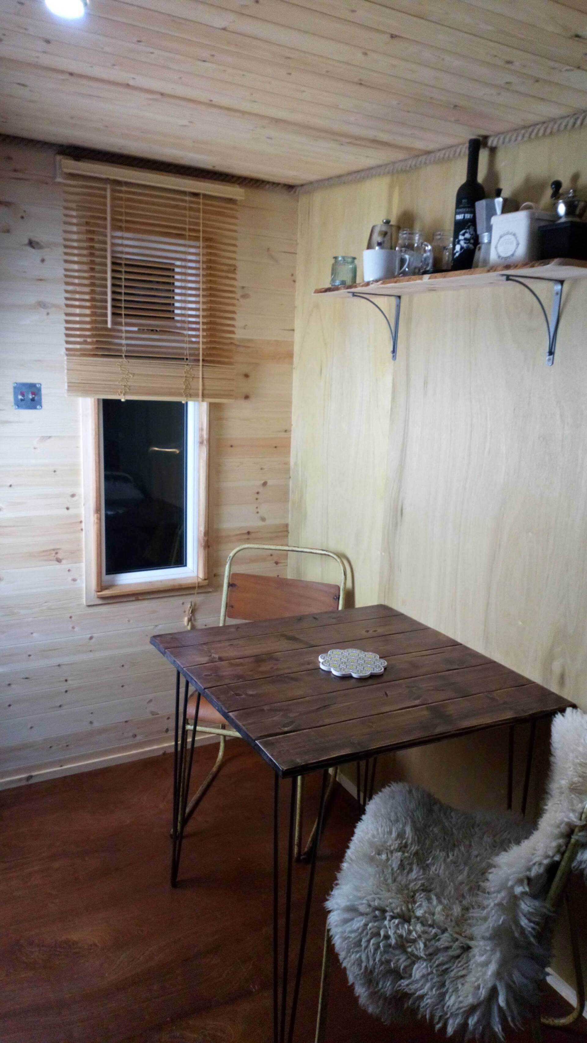 There is a table and chairs in the room.