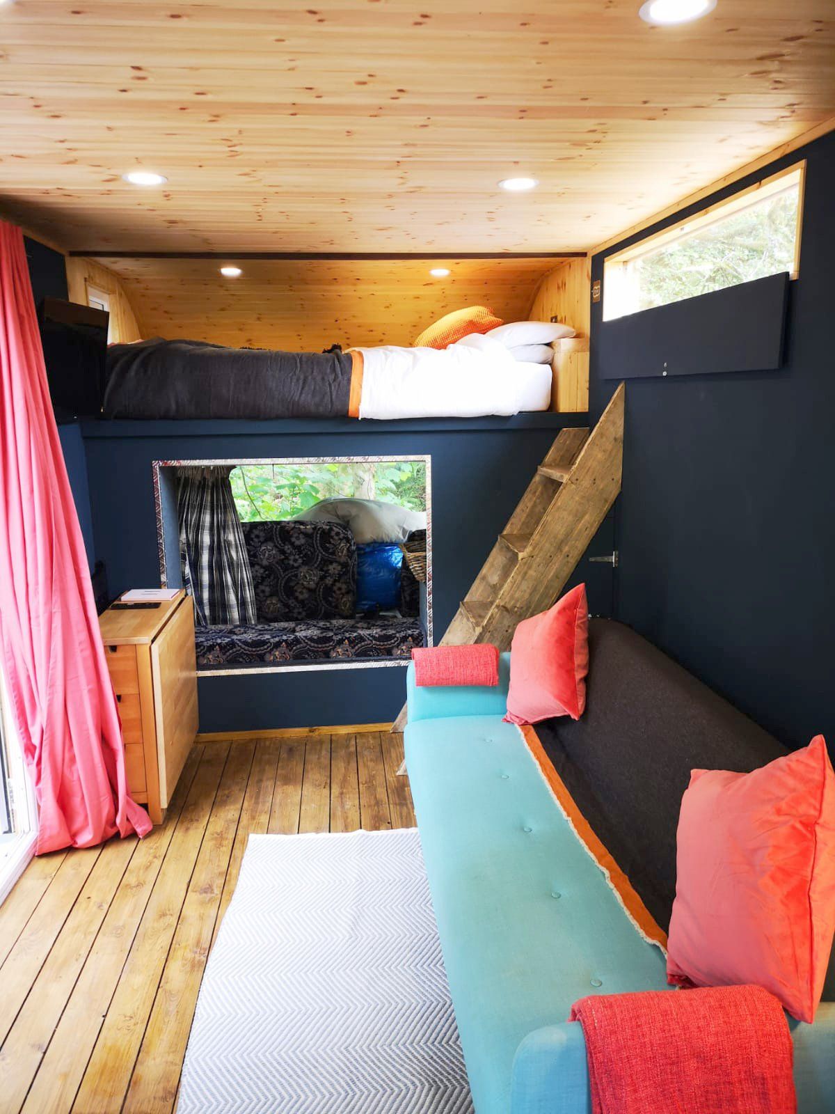 A living room with a bunk bed and a couch.