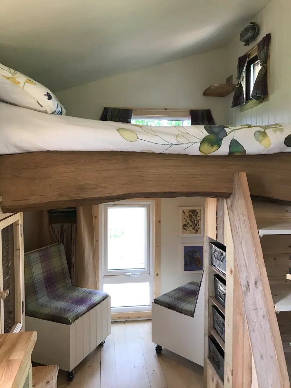 A bedroom with a bunk bed and a window.