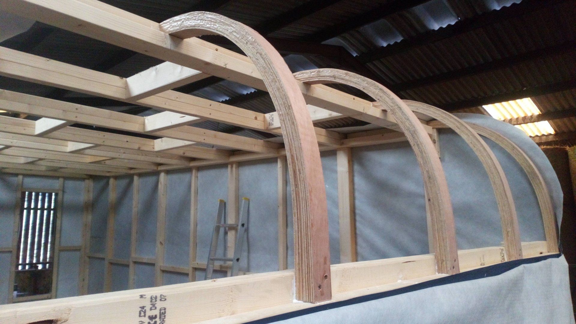 A wooden structure is being built in a warehouse
