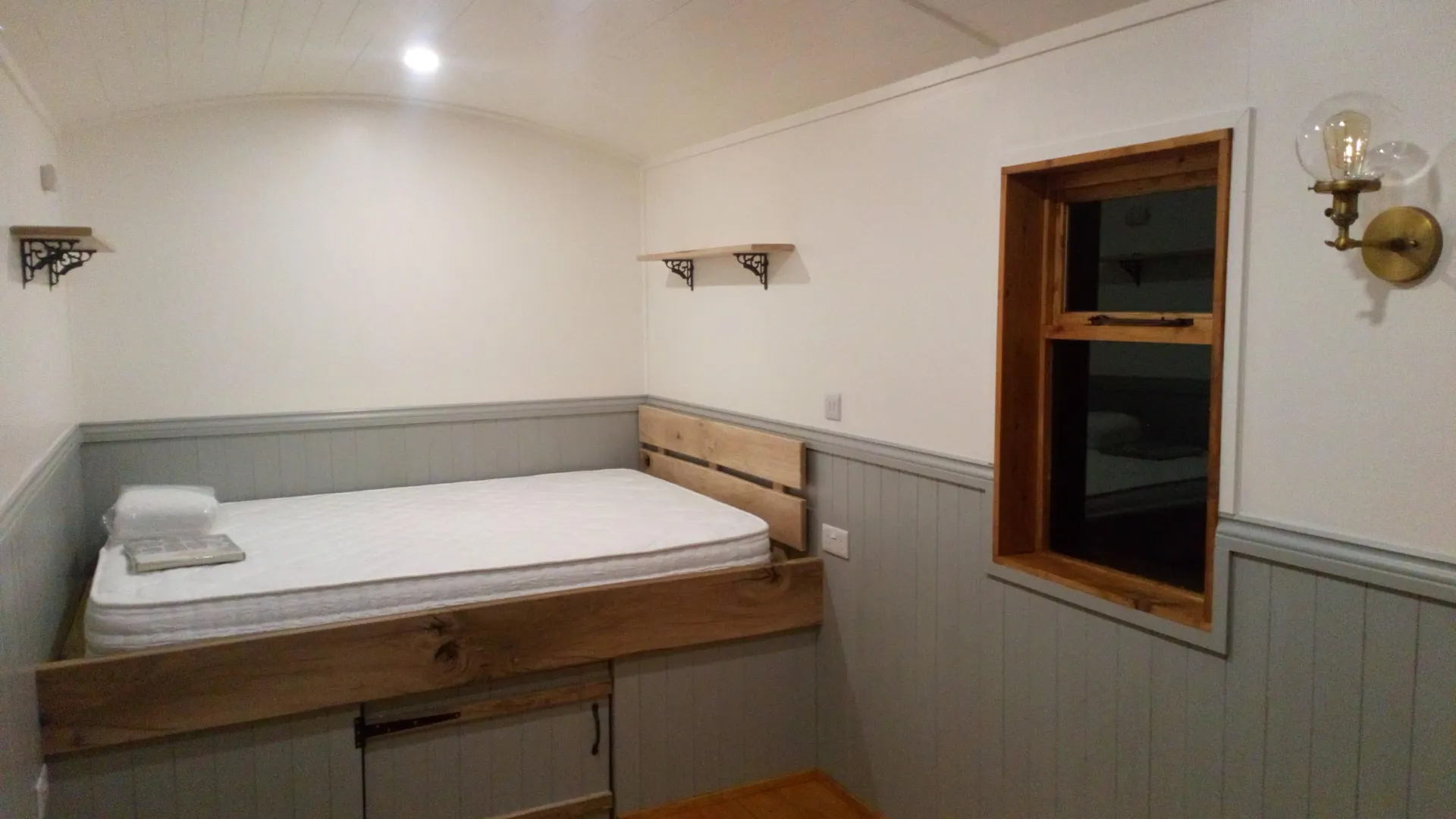 A bedroom with a bed and a window.