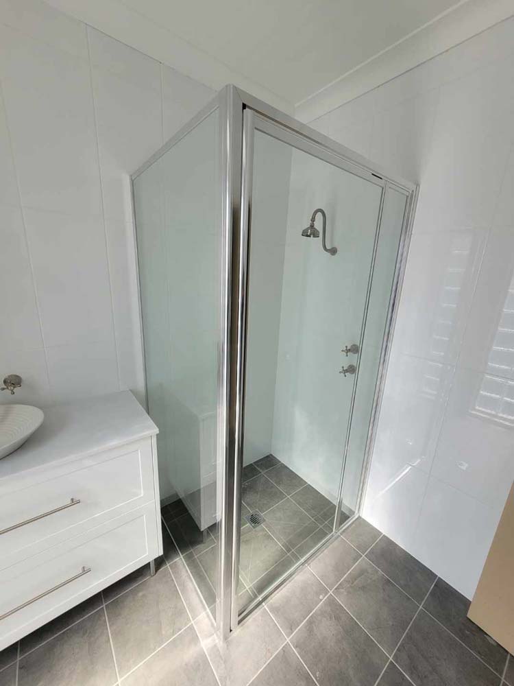 Glass Cubicle Beside A Sink — Shower Screens in Dubbo, NSW