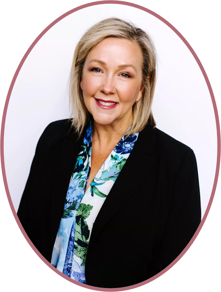 An urn surrounded by white flowers and candles at a memorial service.