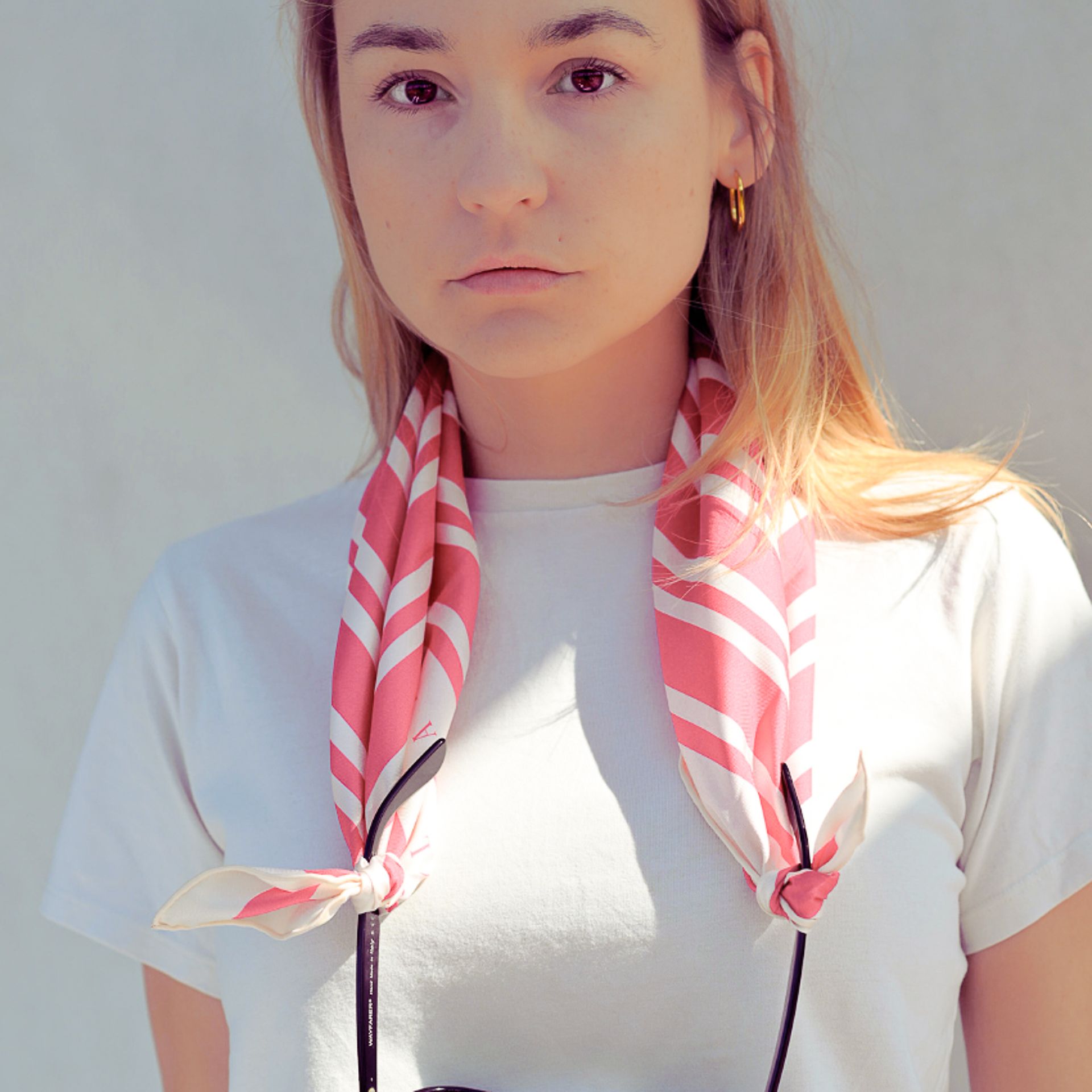 A model wearing a red and white silk scarf, large cream and red geometric silk scarf

