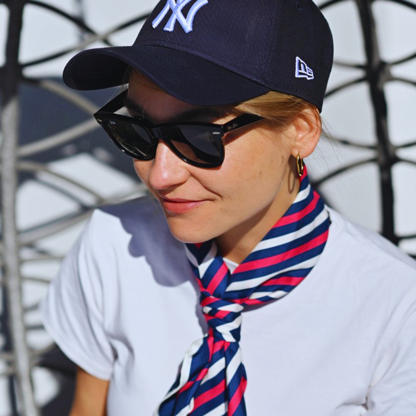 A model wearing a silk scarf around he neck