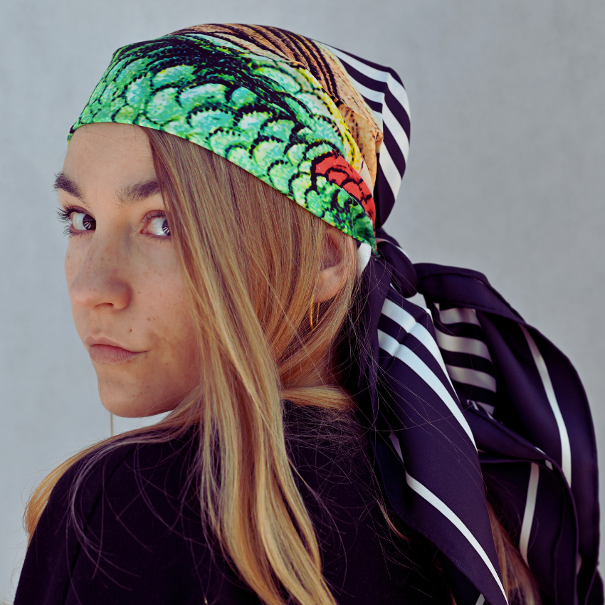 A model wearing a limited hummingbird large silk scarf for women