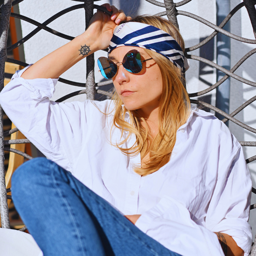 A model outside wearing a silk head scarf