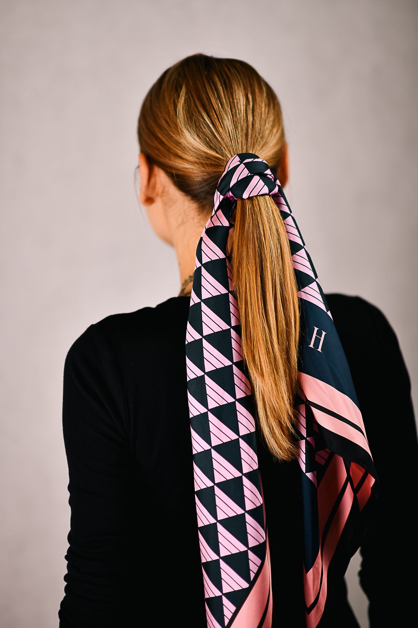 A model wearing a silk scarf in her hair