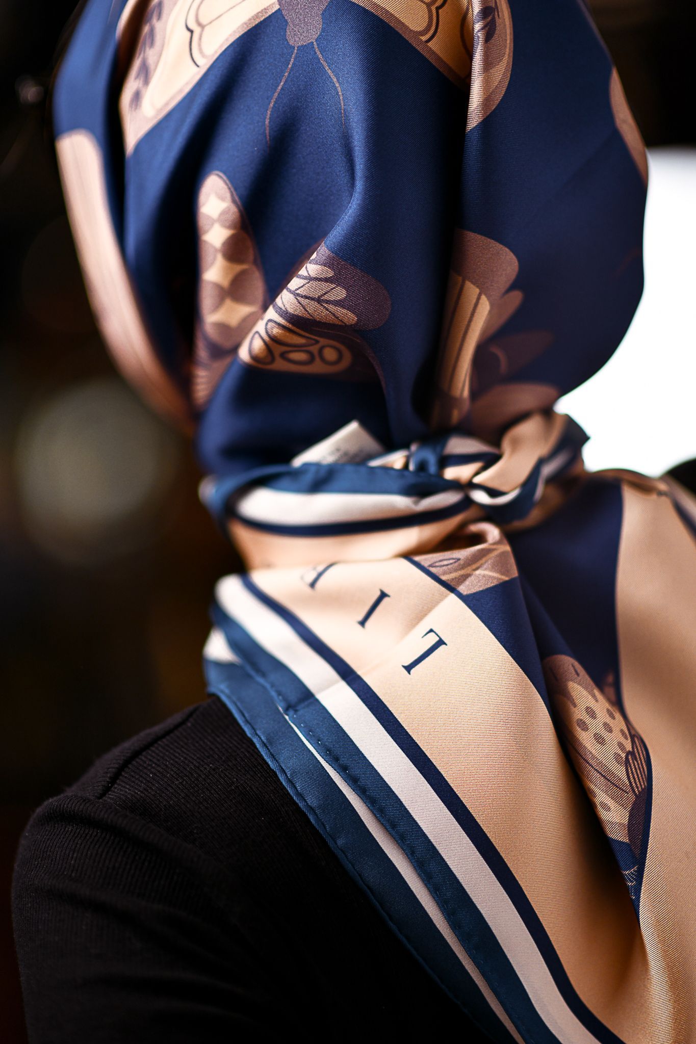 A model wearing a silk head scarf