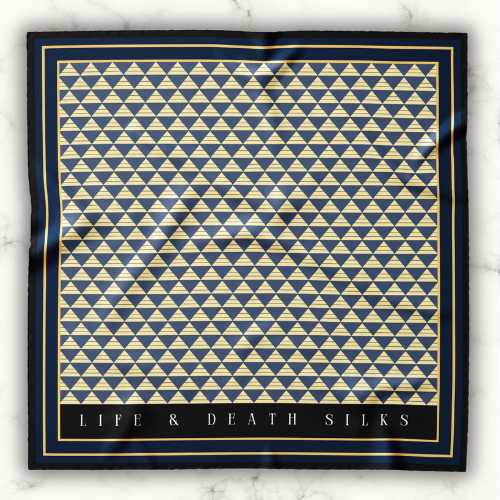 A model wearing an elegant art deco mulberry silk scarf for women, black , blue and gold