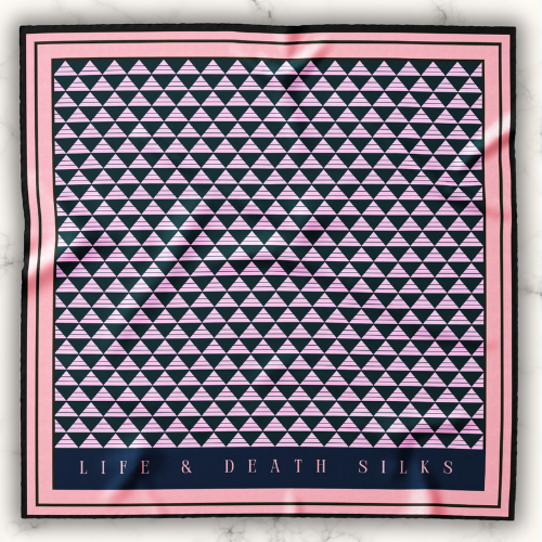 A large art deco black and pink silk scarf