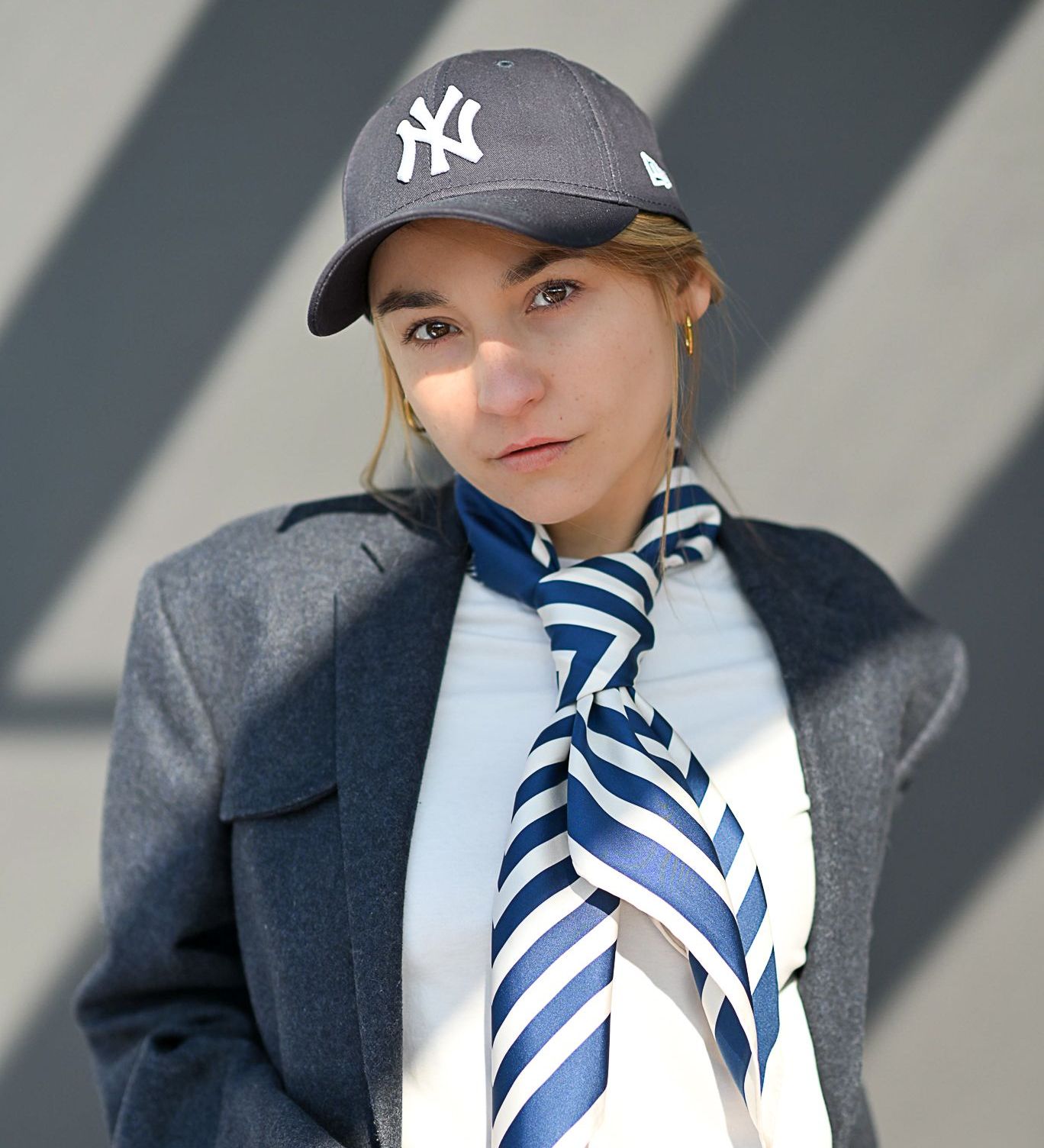 A model wearing a silk scarf for women, a blue and white silk scarf

