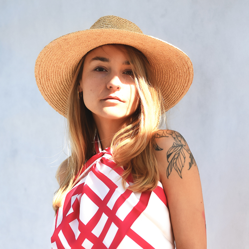 A model wearing a red and cream large silk scarf as a top